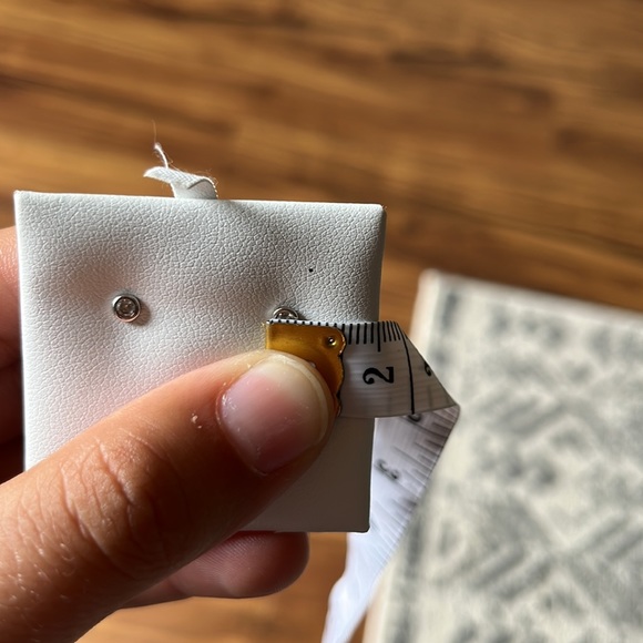 1/10 Ct. Diamond 10k White Gold Bezel Stud Earrings - Picture 10 of 10